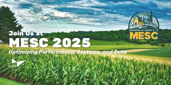 Promotional banner for MESC 2025, held in Milwaukee, WI from August 11–14. The background shows a green cornfield under a partly cloudy sky. Text reads: 'Join Us at MESC 2025 – Optimizing Performance, Systems, and Data.' Includes the MESC 2025 logo with a Milwaukee skyline illustration and the Briljent logo in the bottom left corner.